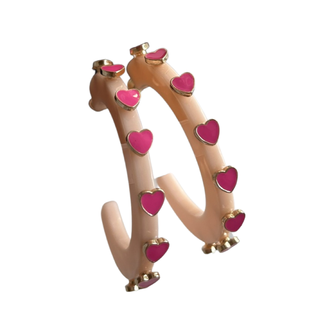 acrylic peach hoop with bright pink heart shaped stones.
