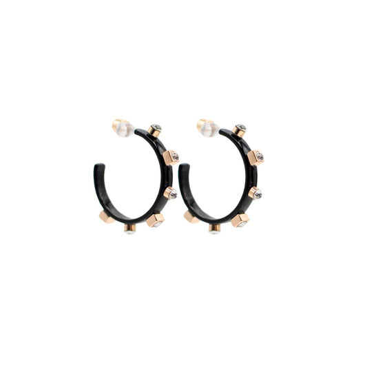 A pair of metallic black hoop earrings with gold studs and clear jewel accents, set against a white background to highlight their reflective surfaces.