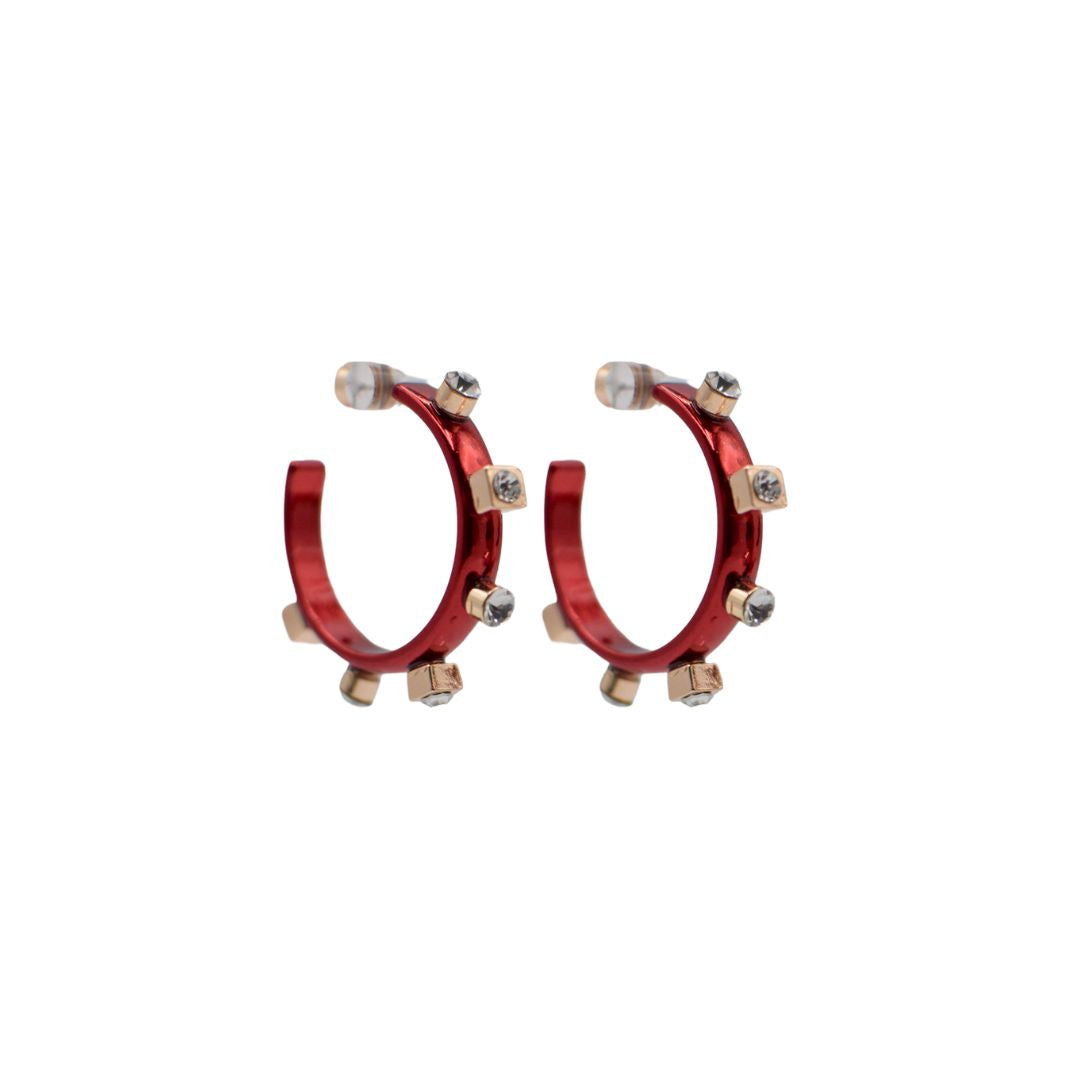 Glossy red hoop earrings with gold accents, adorned with clear jewels. Petite, modern design that combines vibrant color with elegant metallic details.
