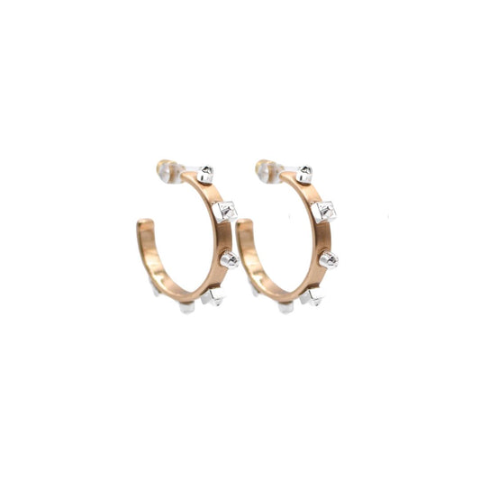 A pair of  gold hoop earrings with matte silver studs, set against a white background to highlight their reflective surfaces.