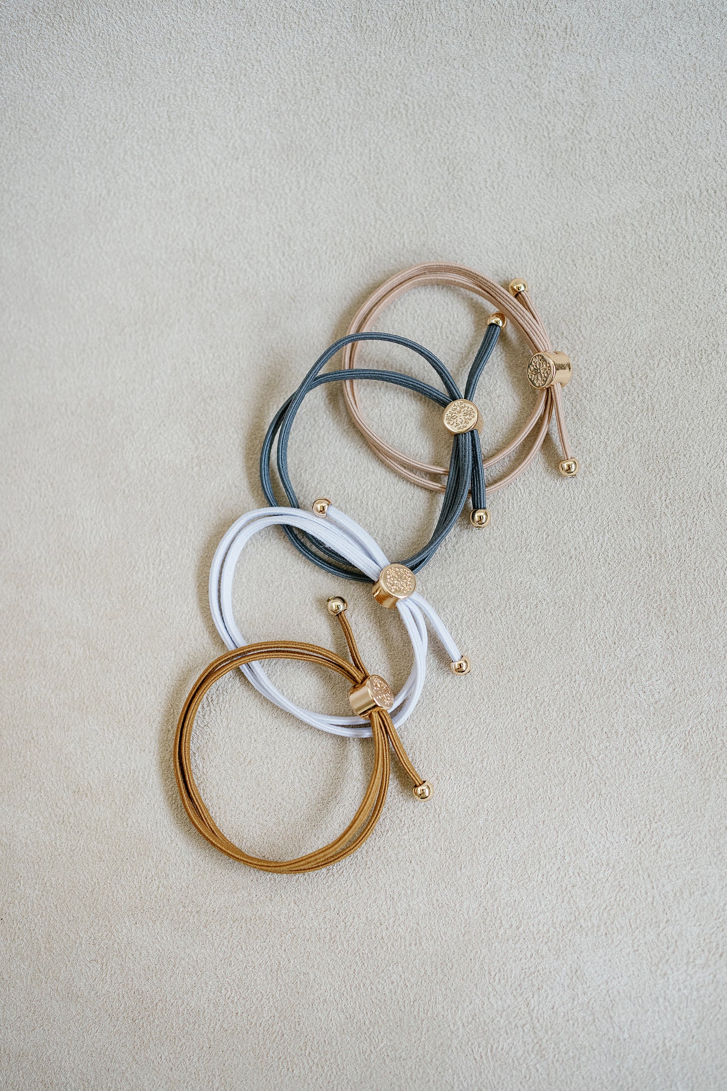 Netural skinny hair tie bracelet set sold in a set of 4 - tan , white , khaki , light grey