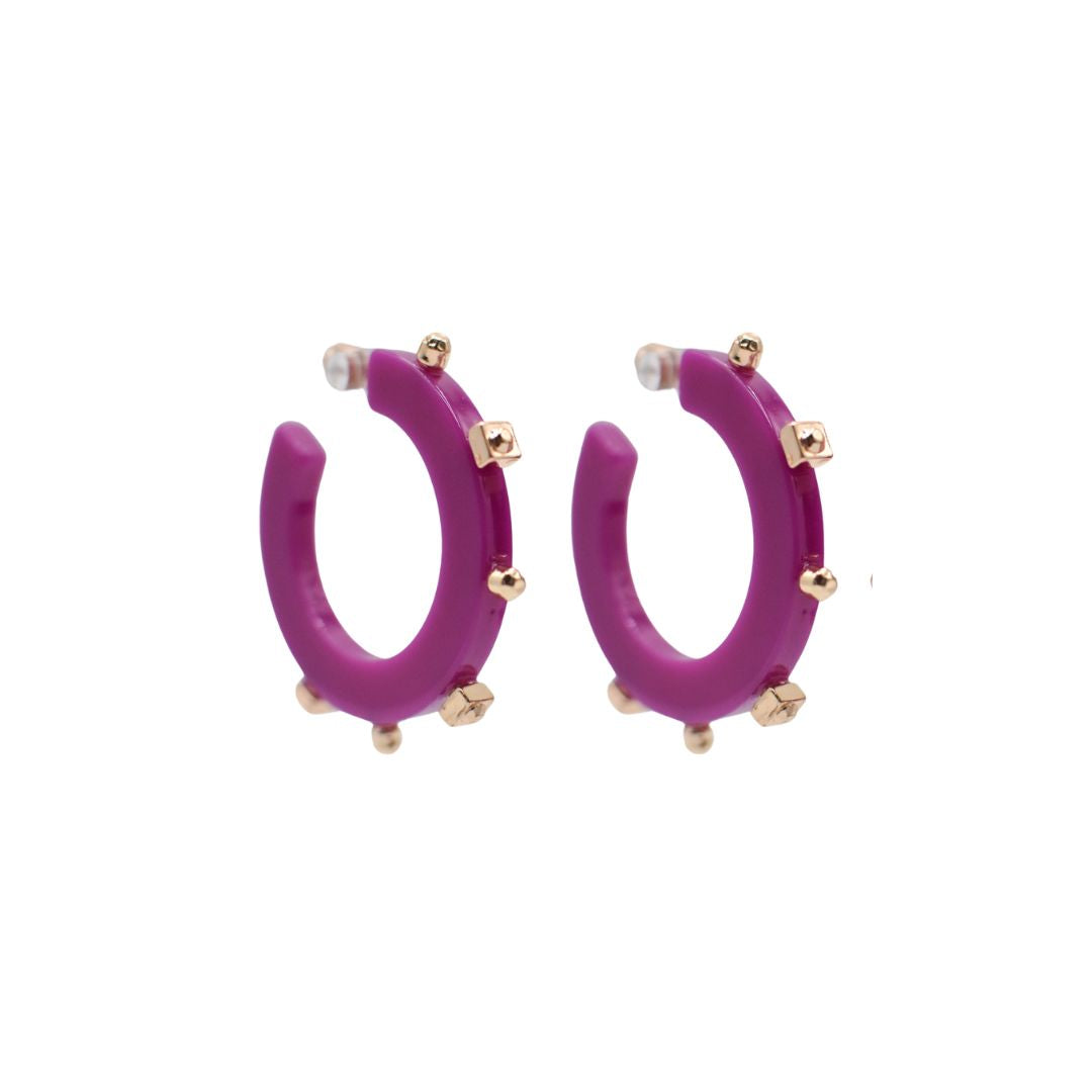 Small vibrant purple open hoop earrings featuring gold-tone studs along the outer edge, with a sleek design and clear post backings for comfortable wear.