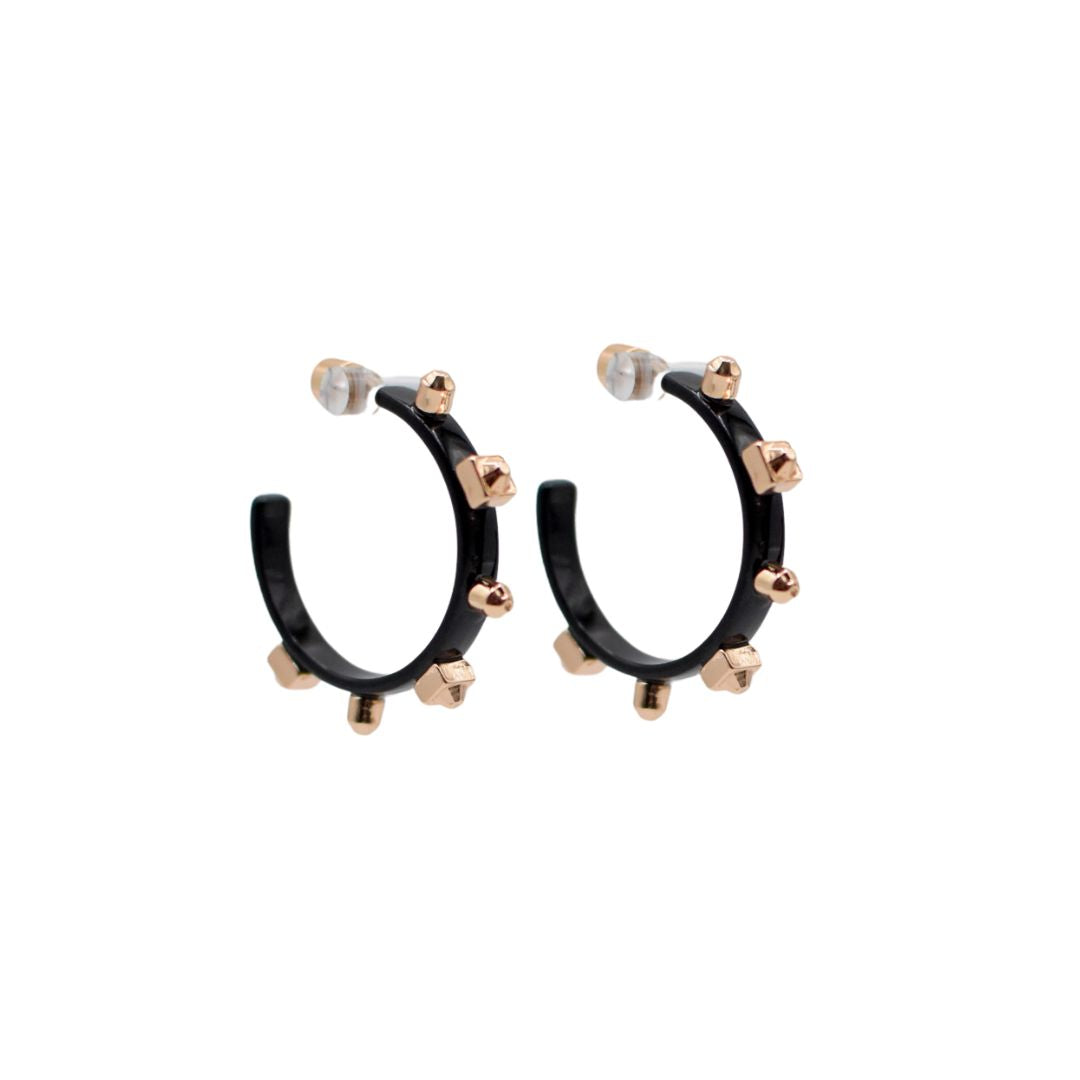 A pair of metallic black hoop earrings with matte gold studs, set against a white background to highlight their reflective surfaces.