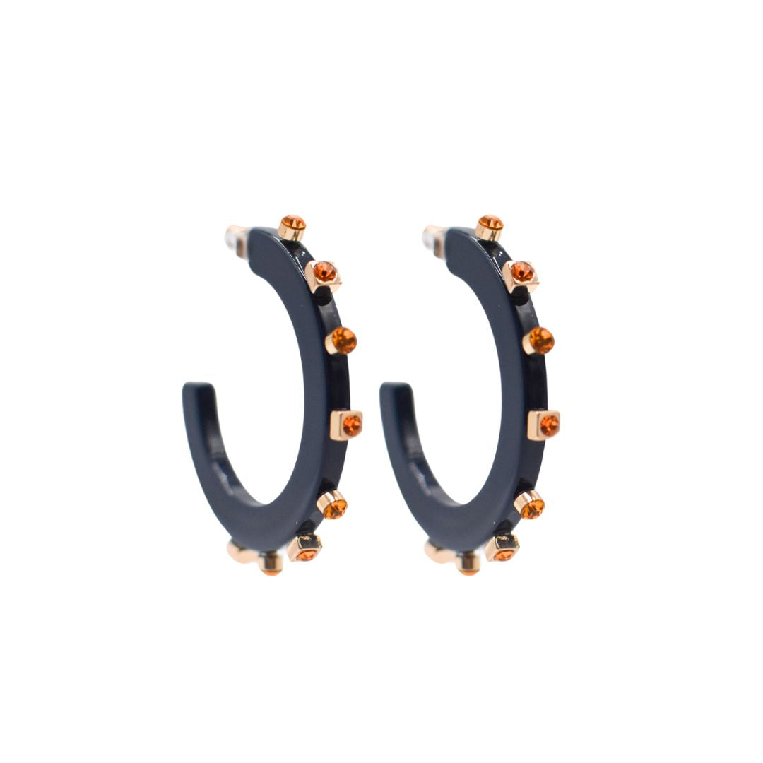 Large navy blue open hoop earrings adorned with gold-tone accents and amber-colored crystal studs, featuring clear post backings for a refined finish.