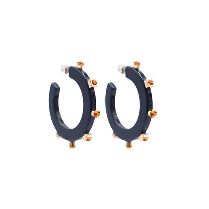 Small navy blue open hoop earrings adorned with gold-tone accents and amber-colored crystal studs, featuring clear post backings for a refined finish.