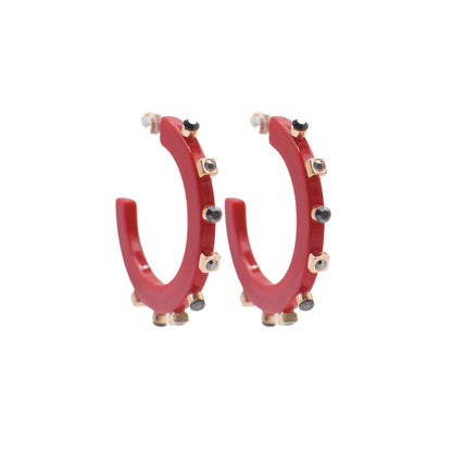 Large bright red open hoop earrings with gold-tone accents and black crystal studs along the edge, featuring a sleek design and clear post backings.