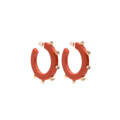 Small red open hoop earrings with gold-tone square and round crystal studs along the outer edge, paired with clear post backings for a sleek finish.