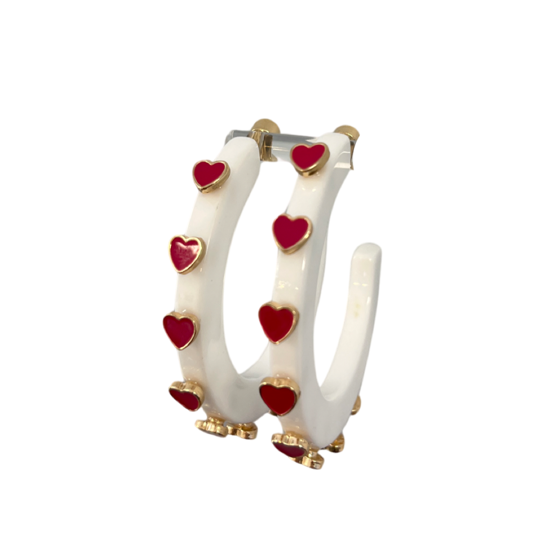 white hoop earring with dark pink heart shaped stones.