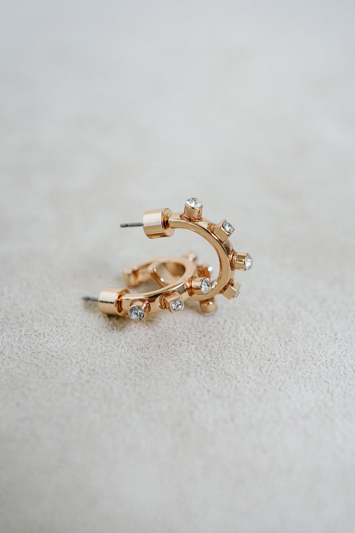 1/2 inch style huggie hoop with gold finish and crystal detil