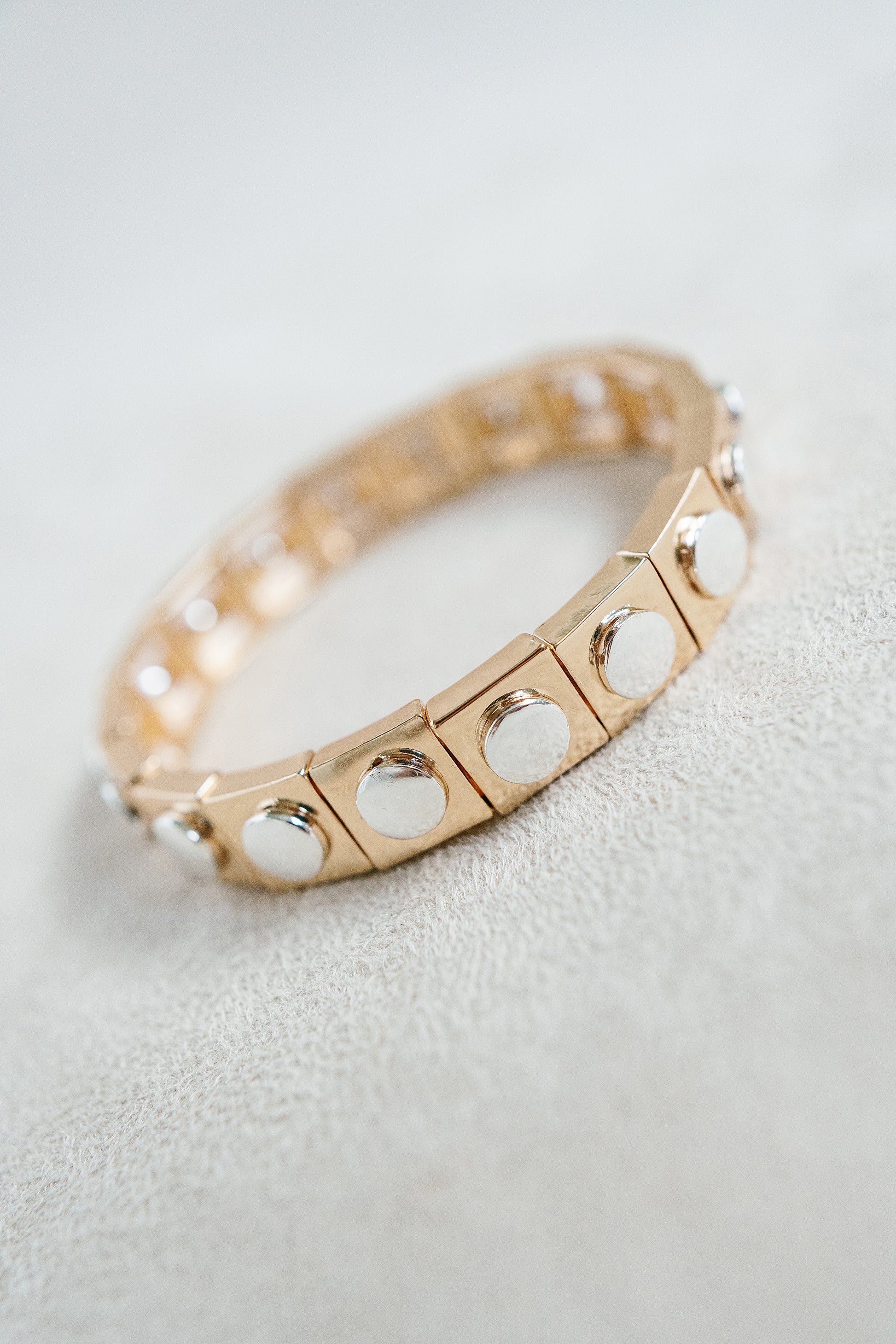 mixed metal gold stretch bracelet with stud detail.