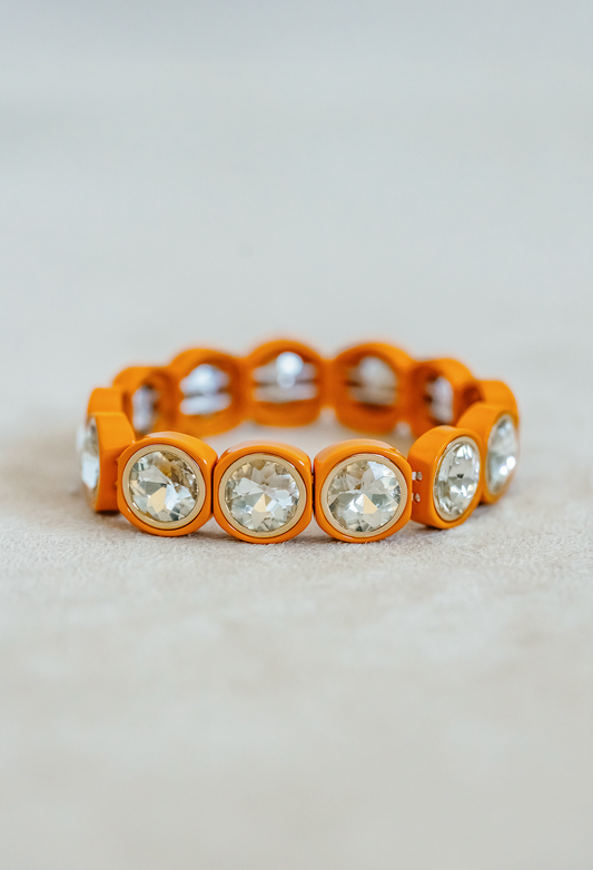 Enamel petite stretch bracelet in orange. Alternating square and circle round stones with acrylic jewels. 