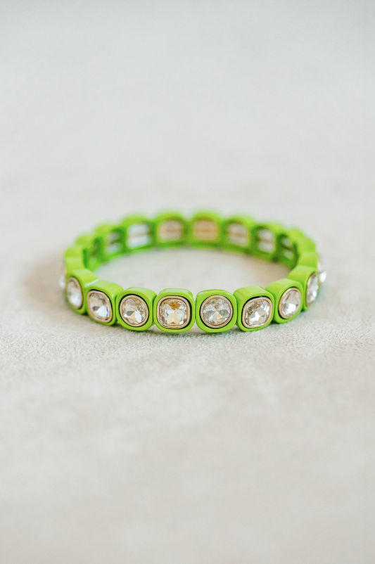 Petite, alternating enamel stretch bracelet. Adjusts to fit wrist with elastic band. Gold detail finish in limeade.