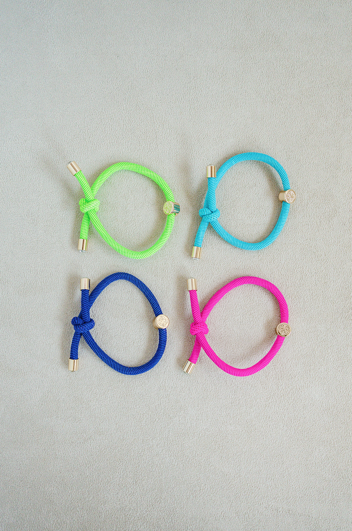 Hair Tie Set set of 4 - knotted hair tie that looks cute on your wrist and in your hair! Knotted detail and gold end caps with jewel center stone. Lime Green , Bright Blue , Indigo Blue and Pink.