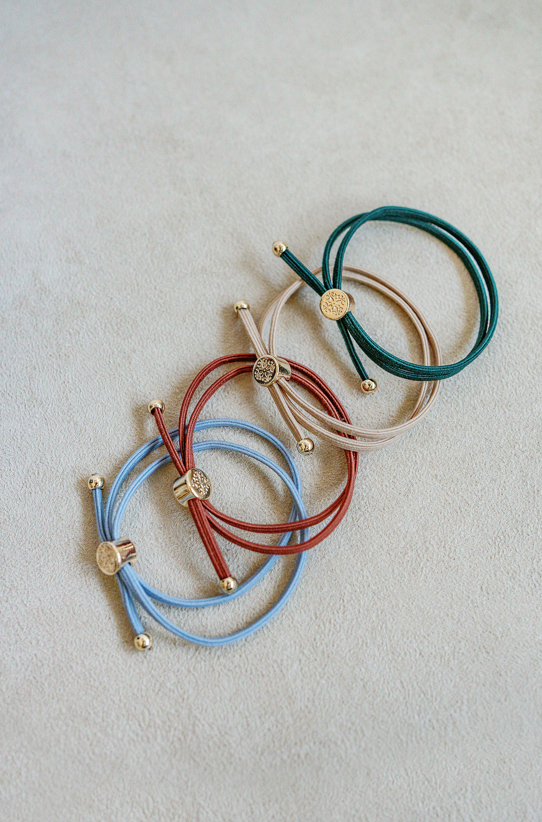 Two in one sleek hair tie bracelet set in dark green, khaki, rustic red and dusty blue.