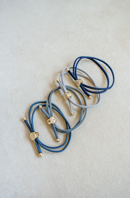 Sleek and Skinny hair tie bracelet in marine sold as set of 4. Blue, Navy, Dark Blue and Grey.