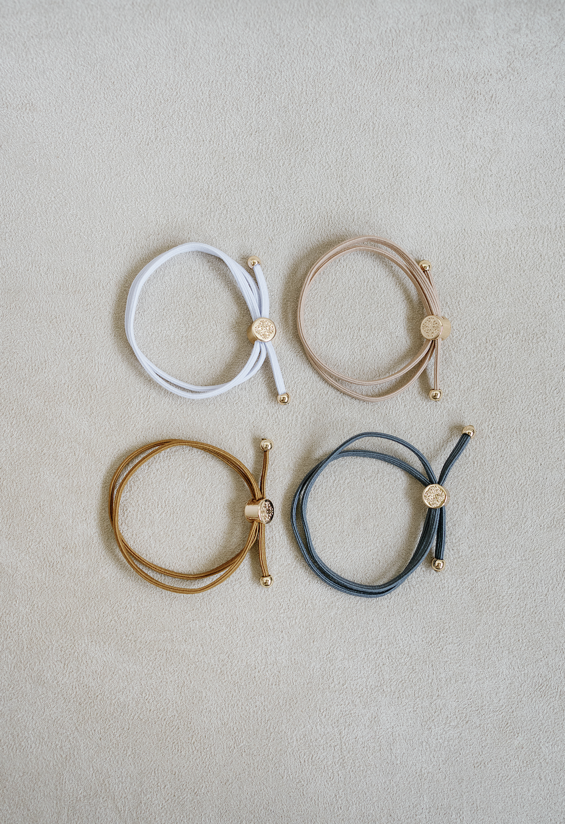 Skinny Hair Tie Set sold as a set of 4 - double wrapped thin hair tie that looks cute on your wrist and in your hair! Minimal sleek style hair tie with round gold end caps and signature gold detail on the end cap.