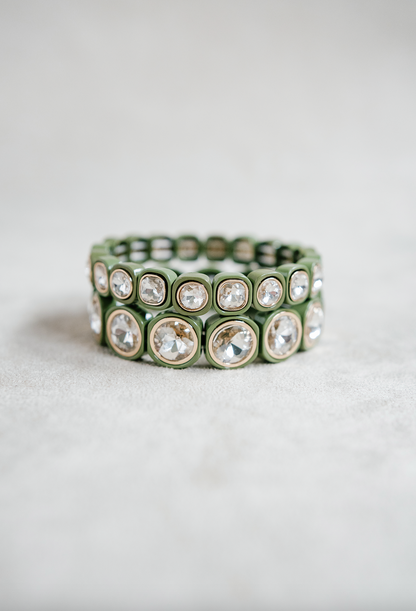 A minimalist bracelet featuring square olive-green acrylic beads, each set with sparkling crystal stones, arranged in a stretchy band design for easy wear. Round and petite bracelet stacked