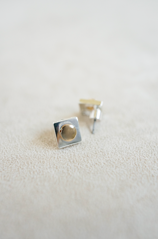 silver square stud with silver round center.