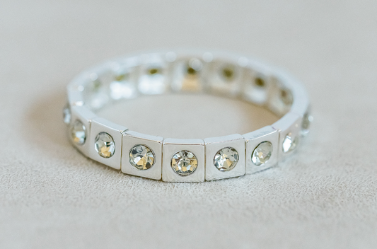 Silver Enamel Stretch Bracelet with acrylic rhinestone detail for a touch of sparkle.