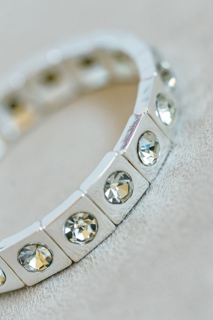 Silver Enamel Stretch Bracelet with acrylic rhinestone detail for a touch of sparkle. Dazzle Silver Bracelet with Mirrored detail 