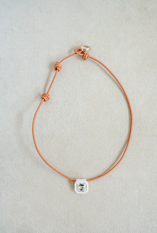 16" candy collar necklace in orangeade. leather orange cord with white enamel pendant. 