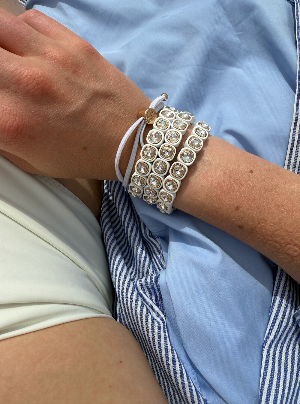 womens bracelets stacked on an arm