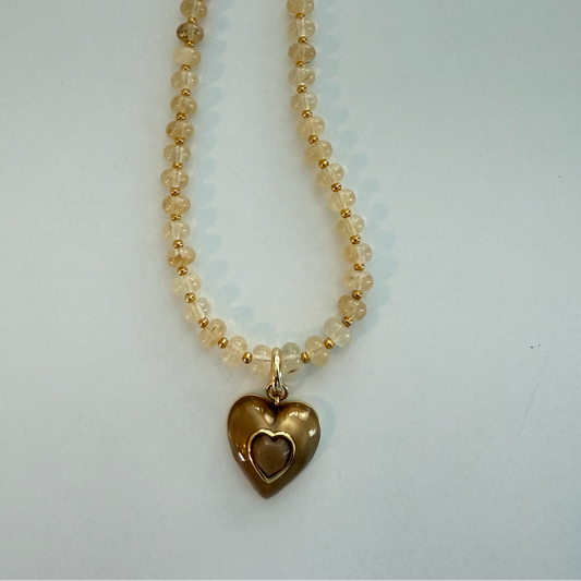 Necklace with heart-shaped pendant on a light gray background