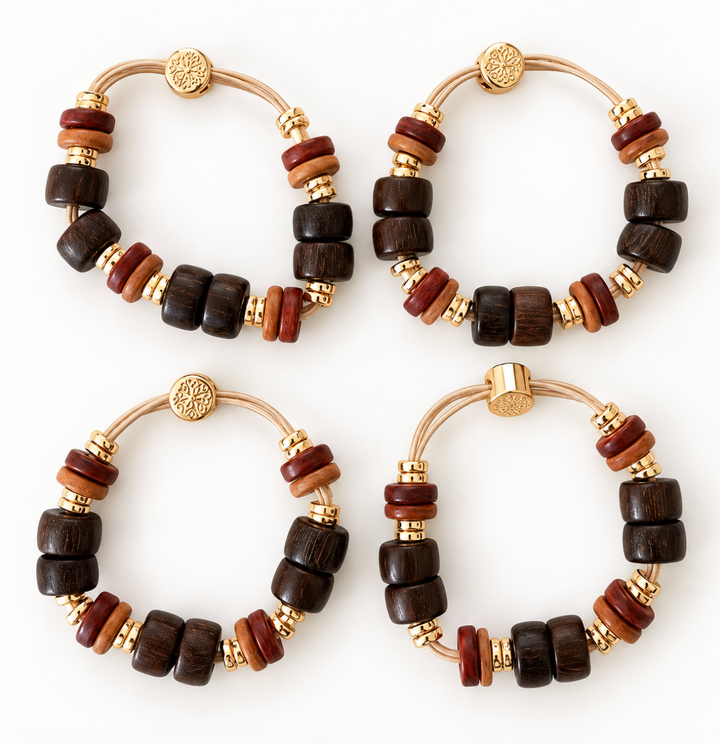 Four matching beaded bracelets arranged in a 2x2 grid on a white background. Each bracelet features dark and medium brown wooden beads, small gold spacer beads, and a gold-toned metal clasp with a round medallion.