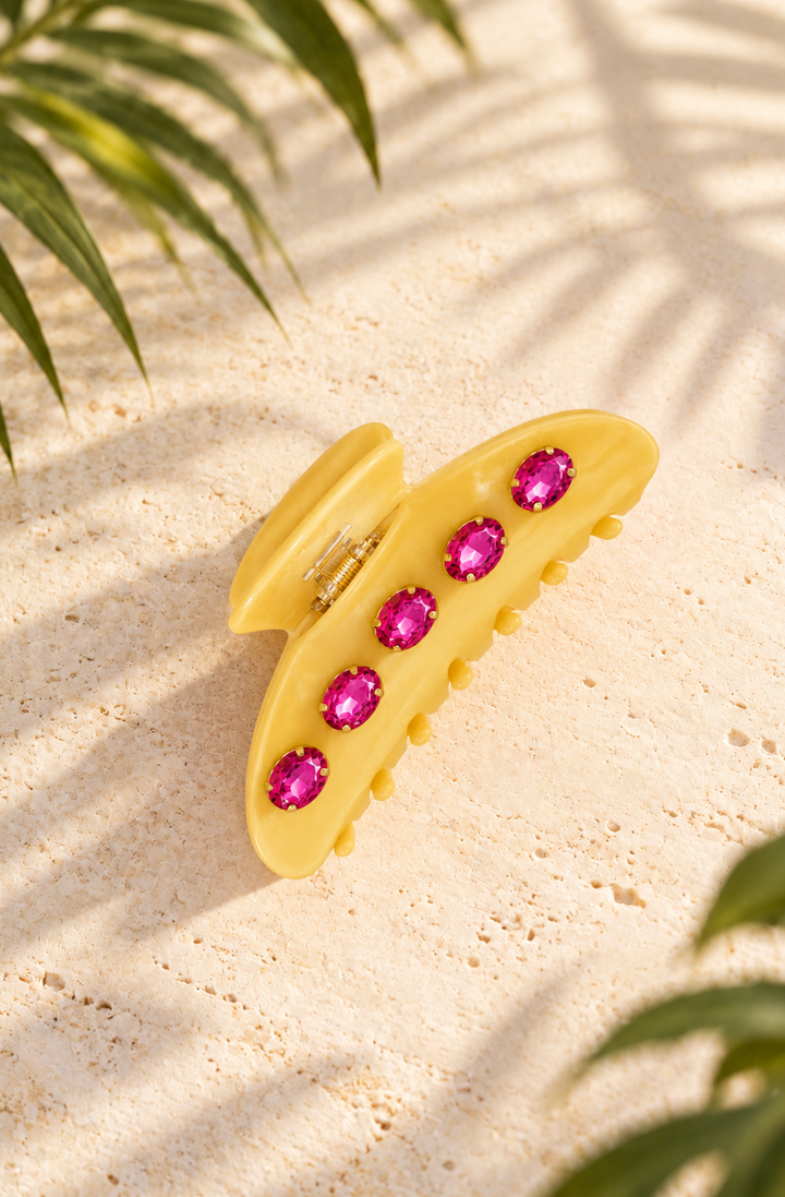 Add a bold pop of color with this butter yellow hair claw clip featuring hot pink  gems, gold-tone hardware, and a secure everyday hold.