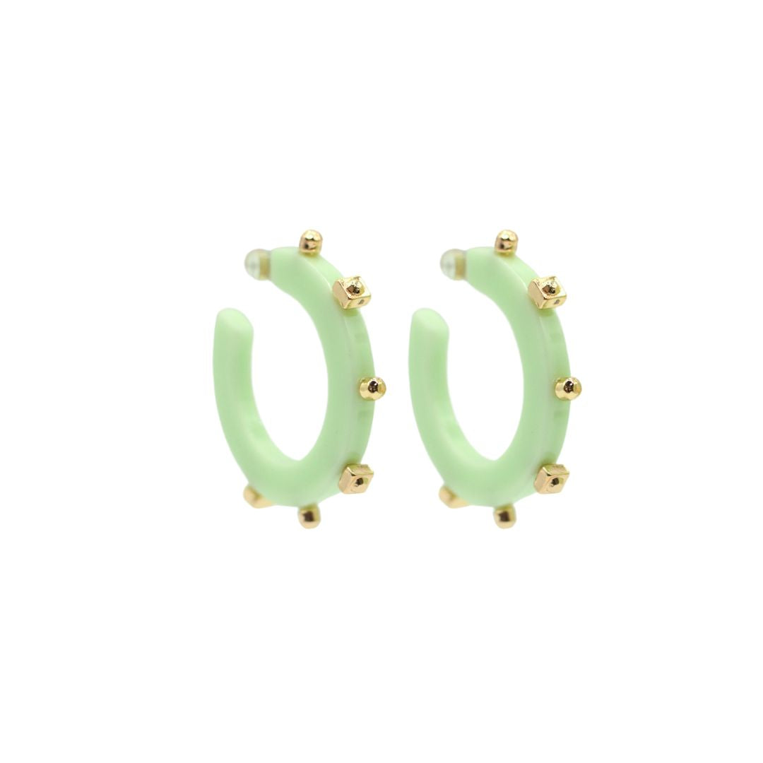 Small pale green open hoop earrings with gold-tone square and round studs along the edge, featuring a sleek, lightweight design and clear post backings.