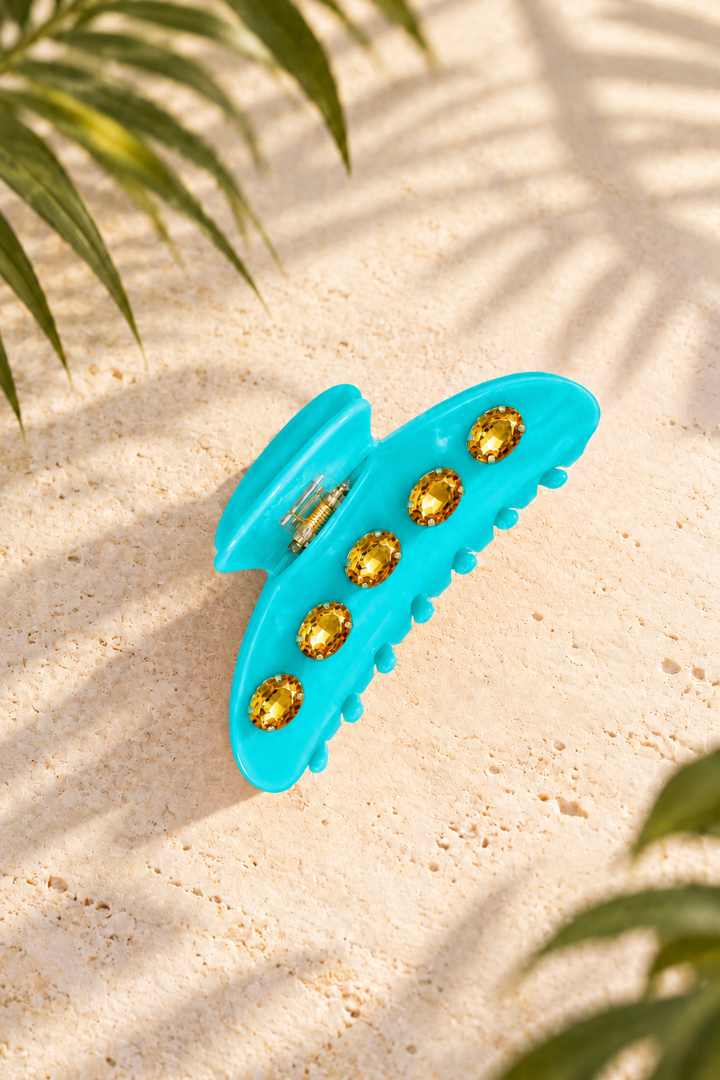 turquoise hair claw clip with five golden rhinestone gems in gold-tone prong settings, shown in model&